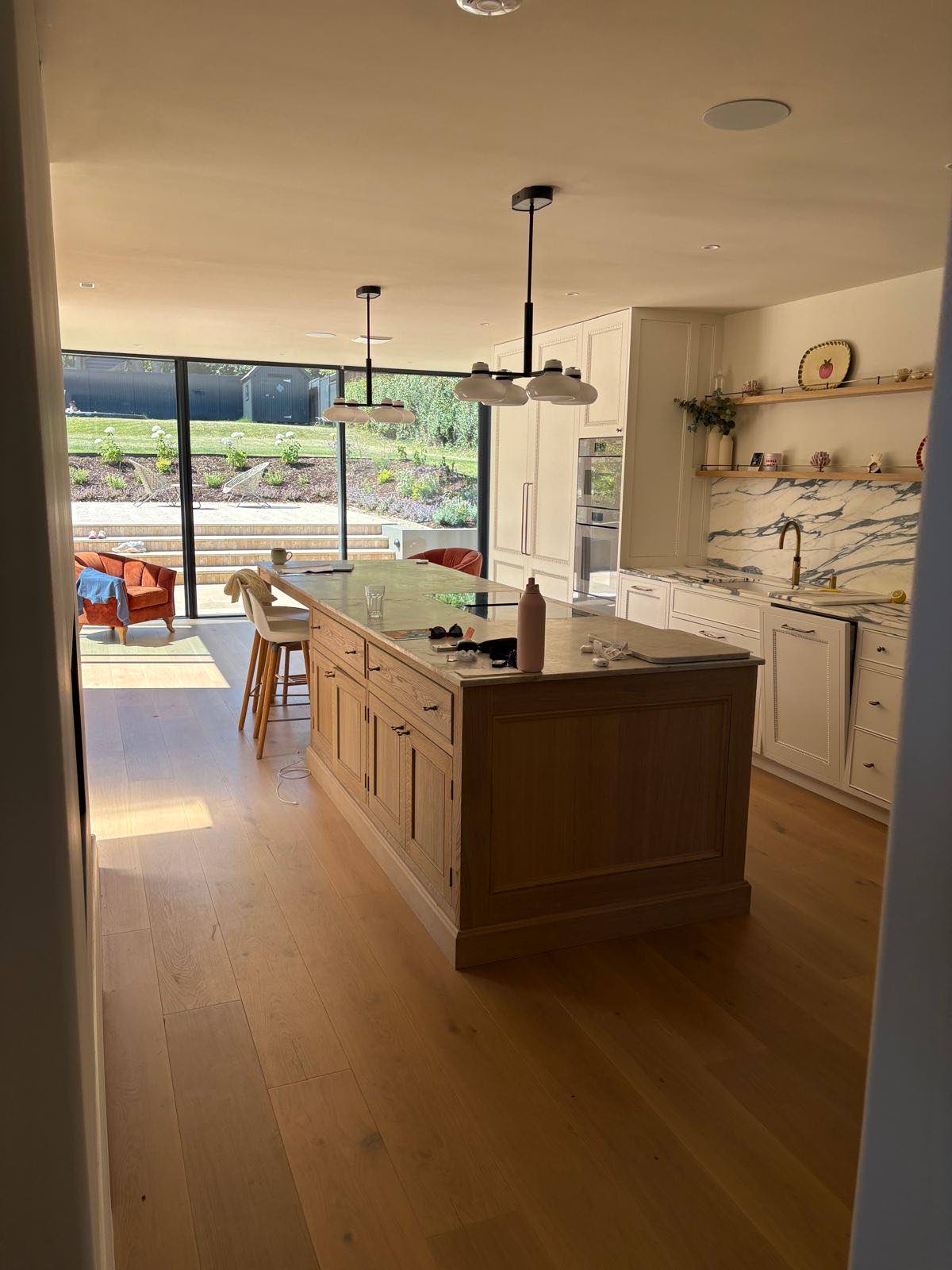 Kitchen with island and full-height glazing