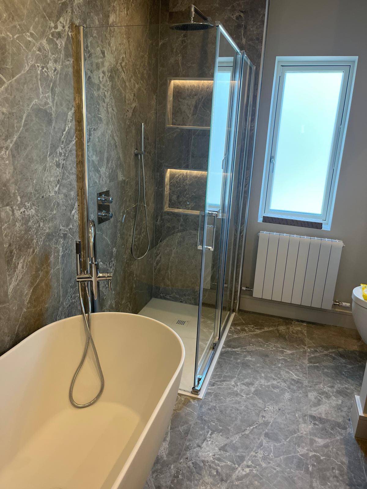 Bathroom with freestanding bath and stone finishes