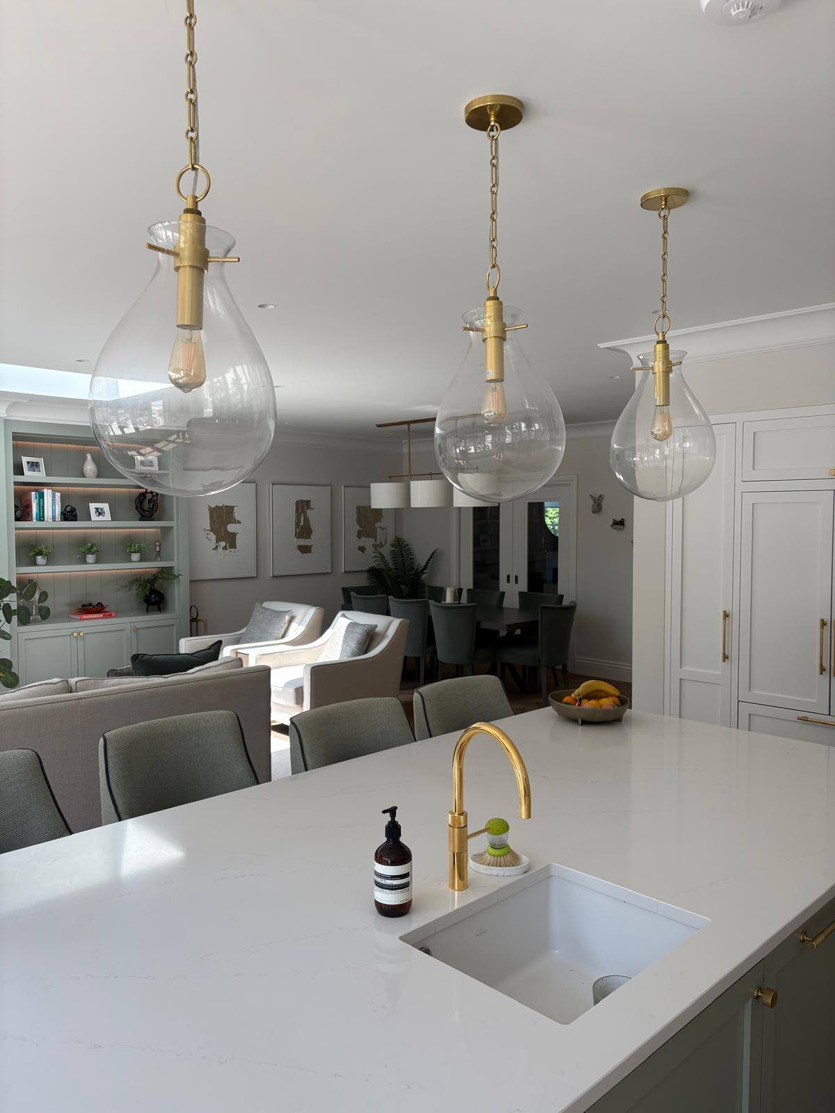 Kitchen island with brass pendants