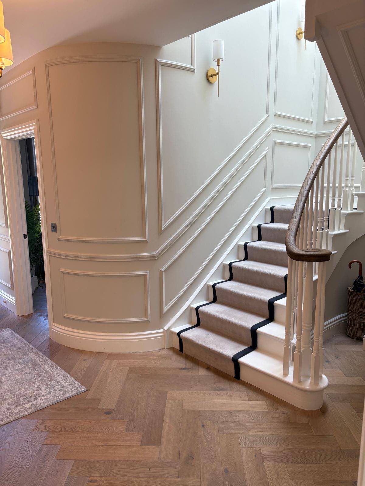 Curved staircase in a panelled entrance hall