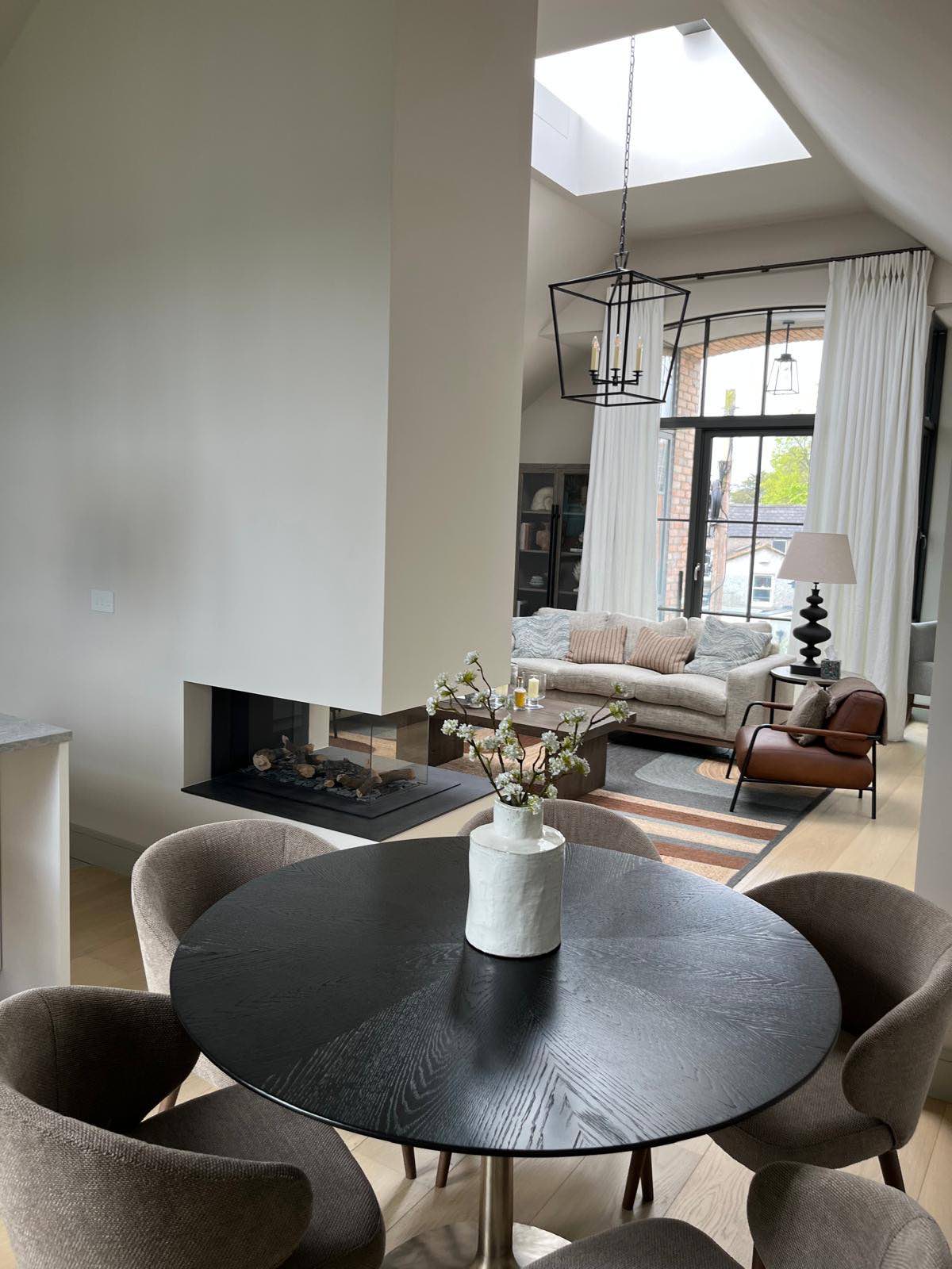 Dining and living space beneath the vaulted ceiling