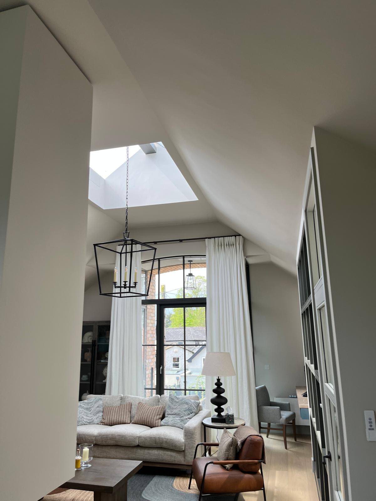 Double-height living space with steel-framed glazing